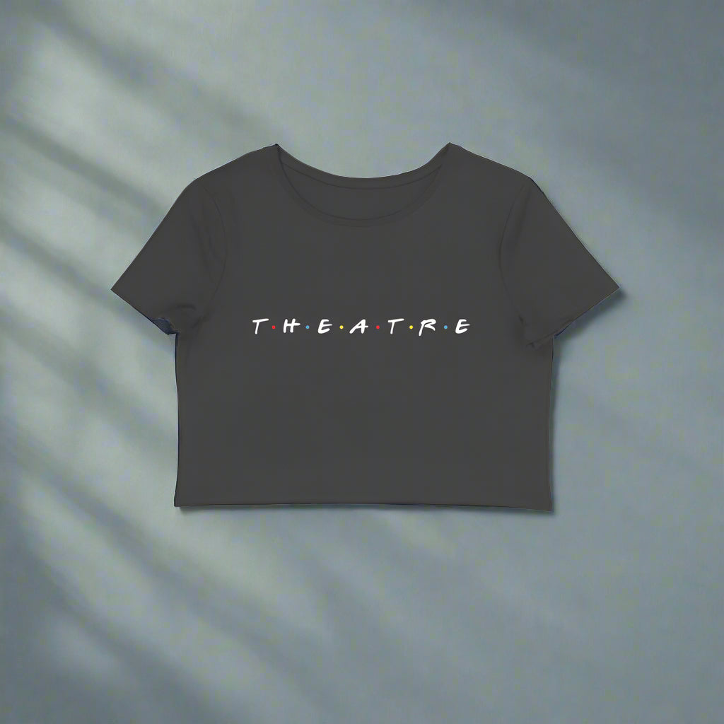 White crop top with the text 'T.H.E.A.T.R.E' printed in black on the front.