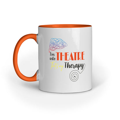 A white ceramic mug with black handle and interior, featuring text and graphics related to theatre therapy.